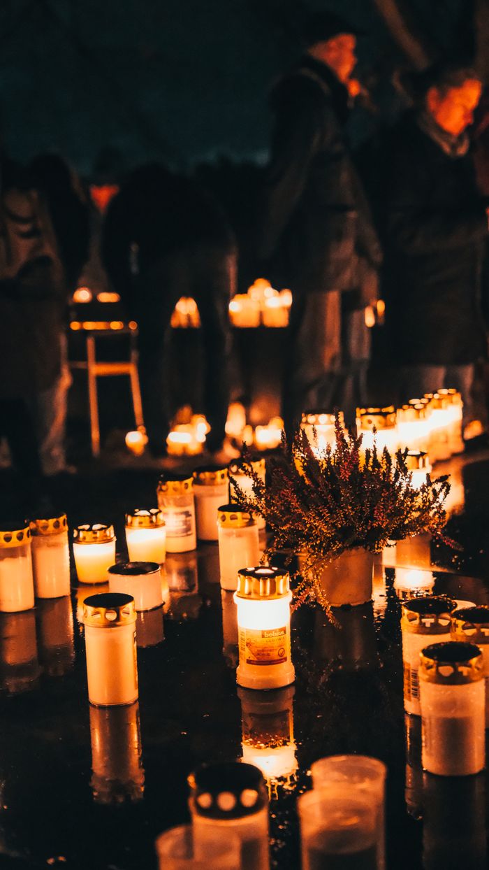 A serene candlelight vigil in Stockholm, Sweden, reflecting peace and unity in a night setting.